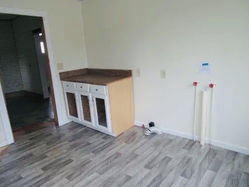 clothes washing area featuring light wood-type flooring