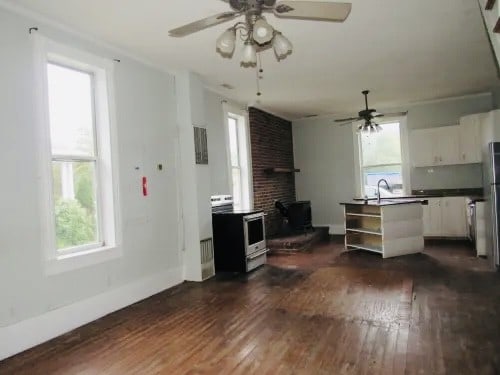 kitchen with white cabinetry, white range with electric cooktop, plenty of natural light, and dark hardwood / wood-style flooring