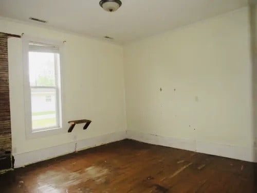 empty room featuring dark hardwood / wood-style flooring