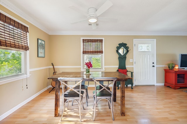 dining room featuring light hardwood / wood-style flooring, ceiling fan, and crown molding