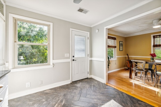 entrance foyer with dark parquet flooring and crown molding