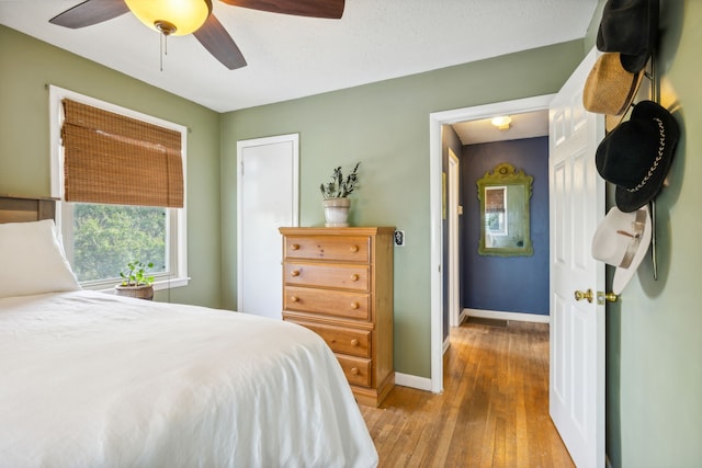 bedroom with ceiling fan and light hardwood / wood-style flooring