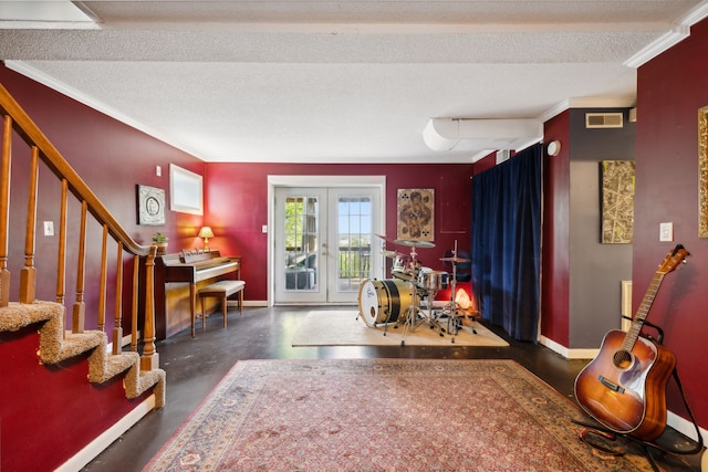 interior space with a textured ceiling, ornamental molding, and french doors