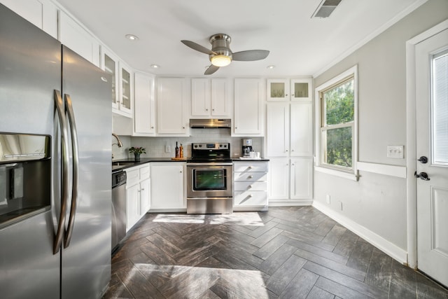 kitchen featuring stainless steel appliances, white cabinets, and crown molding