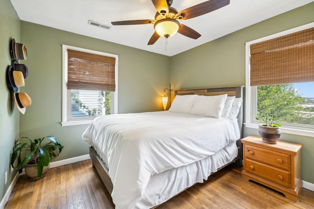 bedroom with ceiling fan and dark hardwood / wood-style floors