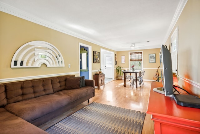 living room featuring ornamental molding, hardwood / wood-style floors, and ceiling fan