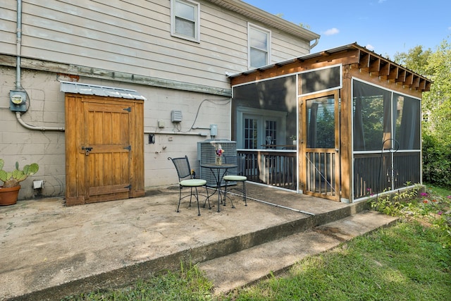 back of house featuring a sunroom and a patio area