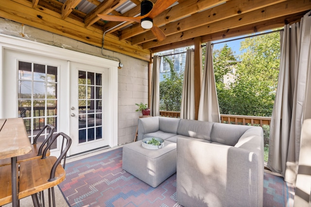 sunroom / solarium featuring beam ceiling, ceiling fan, and french doors