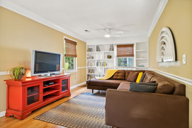 living room with wood-type flooring, plenty of natural light, and crown molding