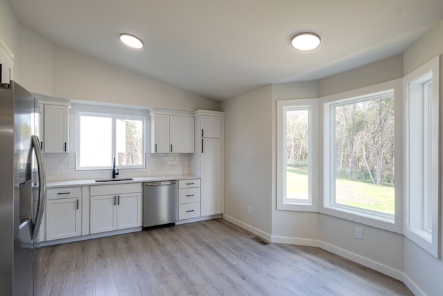 kitchen with white cabinetry, plenty of natural light, and appliances with stainless steel finishes