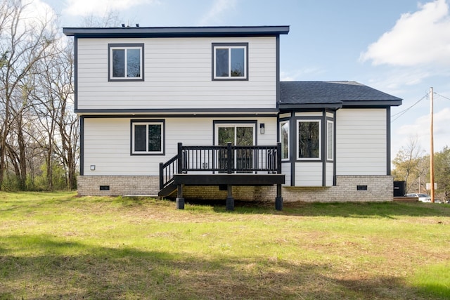 back of house with a wooden deck and a lawn