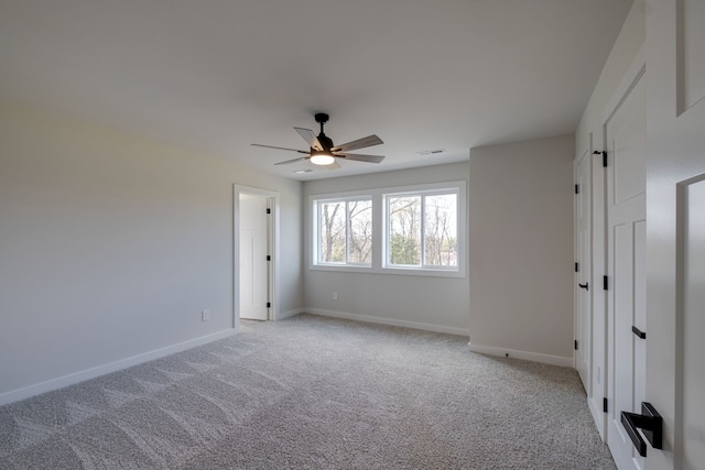 spare room with light carpet and ceiling fan