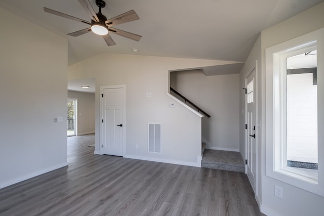 unfurnished living room with wood-type flooring, vaulted ceiling, and ceiling fan