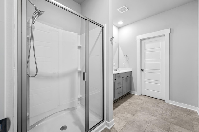 bathroom featuring vanity and a shower with door