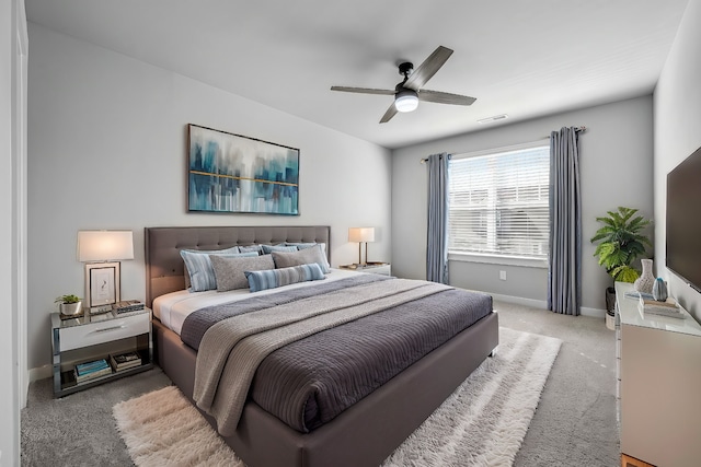 bedroom with light carpet and ceiling fan