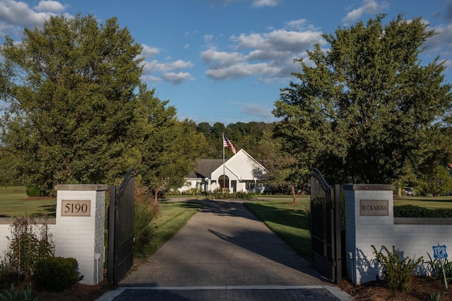 view of gate featuring a lawn