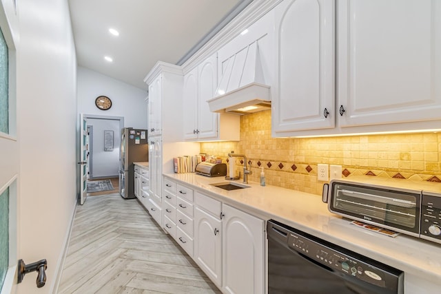 kitchen with stainless steel fridge, sink, white cabinetry, and black dishwasher