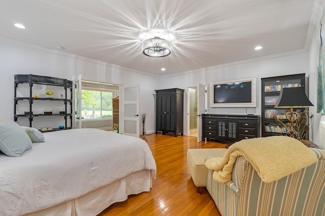 bedroom featuring hardwood / wood-style flooring, a chandelier, and ornamental molding