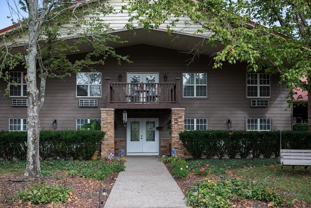 view of front facade featuring a balcony and french doors