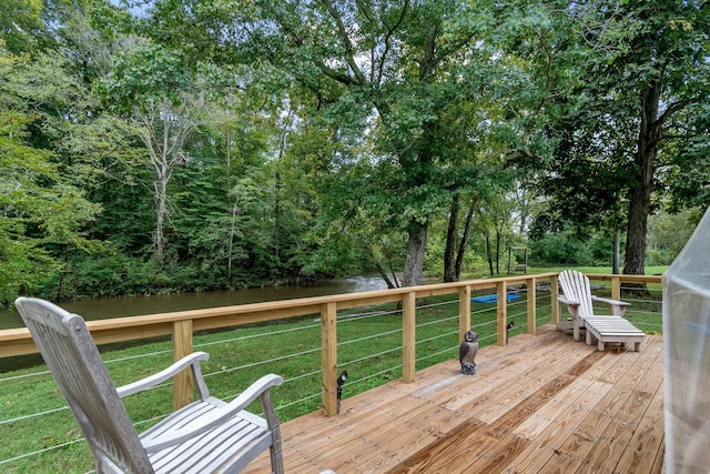 wooden terrace with a lawn and a water view