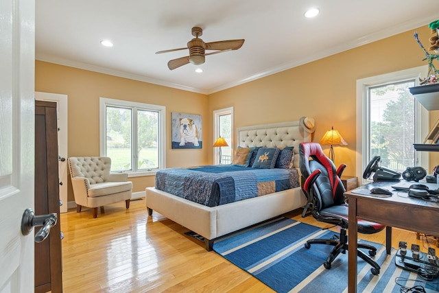 bedroom featuring ornamental molding, ceiling fan, light hardwood / wood-style flooring, and multiple windows