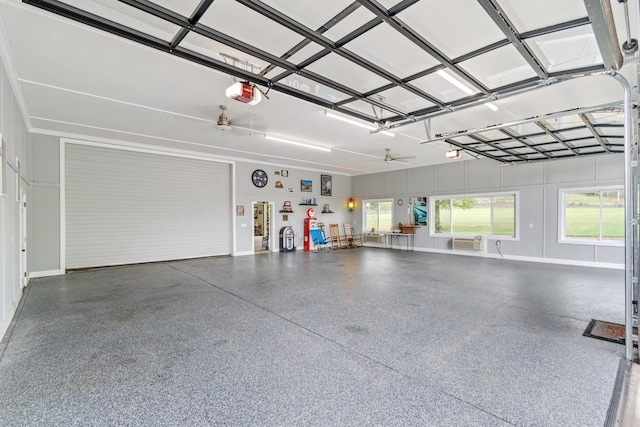 garage with ceiling fan and a garage door opener