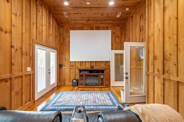 living room featuring wood ceiling, vaulted ceiling, french doors, and light hardwood / wood-style floors