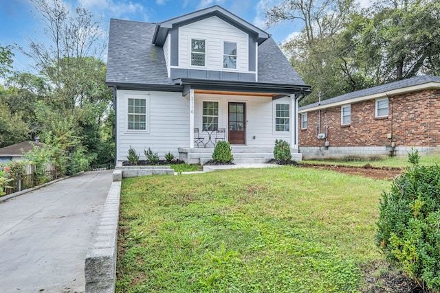 view of front of house with a front yard and a porch