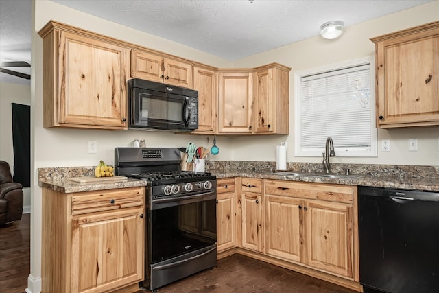 kitchen with light brown cabinets, sink, black appliances, a textured ceiling, and dark hardwood / wood-style flooring