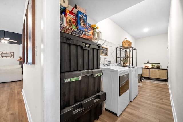 laundry room with ceiling fan, light wood-type flooring, and washing machine and clothes dryer