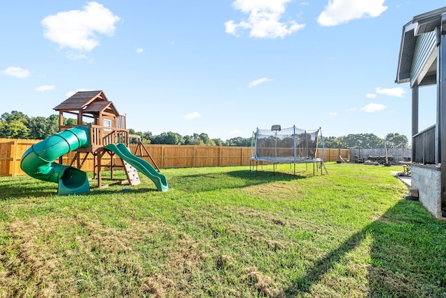 view of jungle gym with a trampoline and a lawn