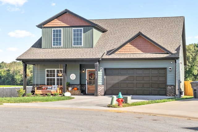 craftsman inspired home with a garage and a porch