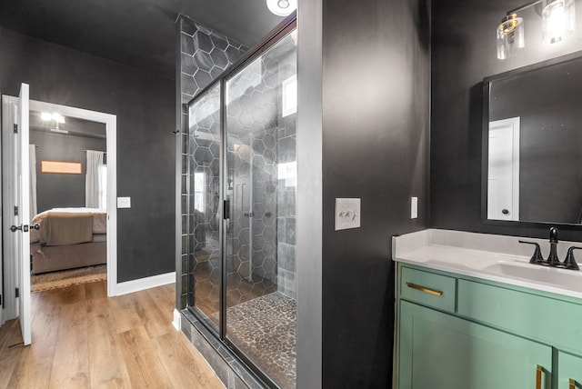 bathroom with vanity, a shower with door, and hardwood / wood-style flooring