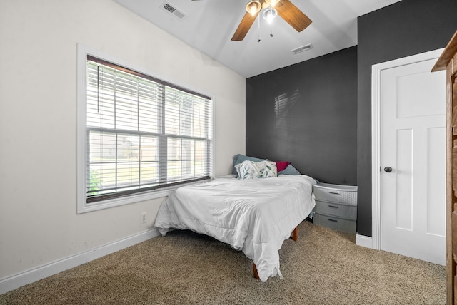 carpeted bedroom with multiple windows and ceiling fan