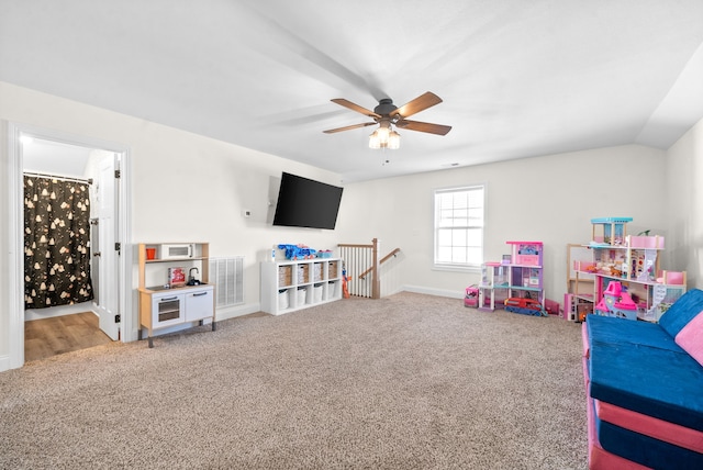 playroom featuring ceiling fan, vaulted ceiling, and carpet