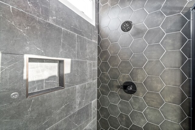 bathroom with a tile shower