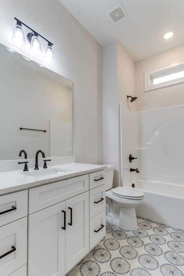 full bathroom featuring vanity, bathtub / shower combination, and toilet