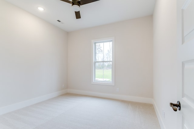 empty room with ceiling fan and light colored carpet