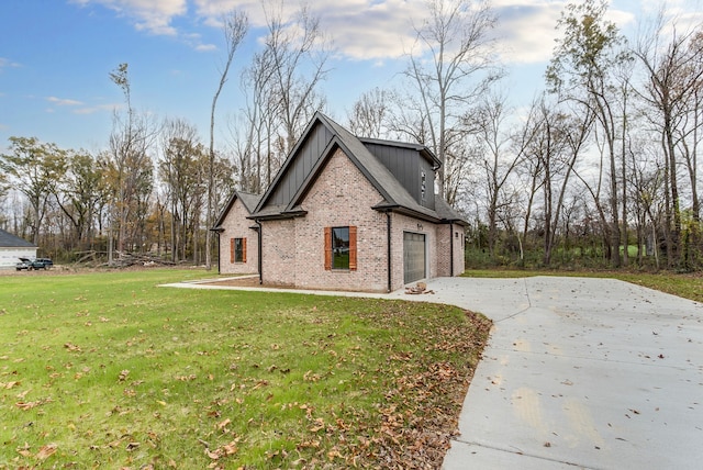 view of side of property with a lawn and a garage