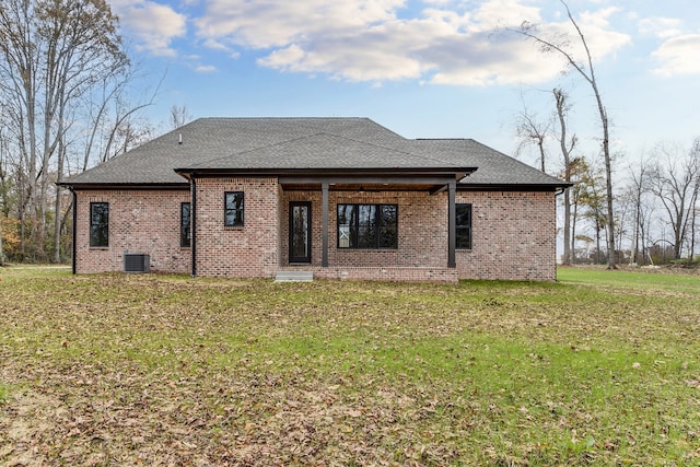 back of house with a yard and central air condition unit