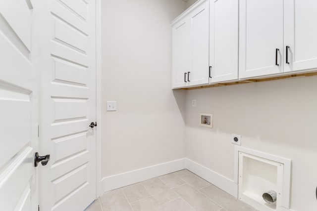 washroom featuring hookup for an electric dryer, cabinets, light tile patterned floors, and washer hookup