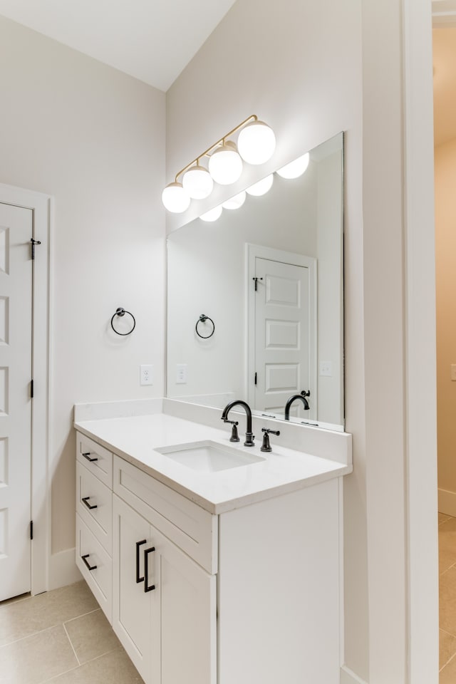 bathroom featuring tile patterned flooring and vanity