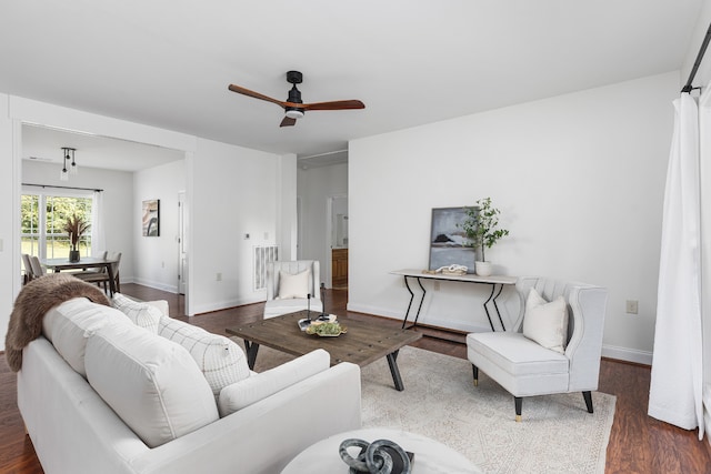 living room with ceiling fan and dark hardwood / wood-style floors