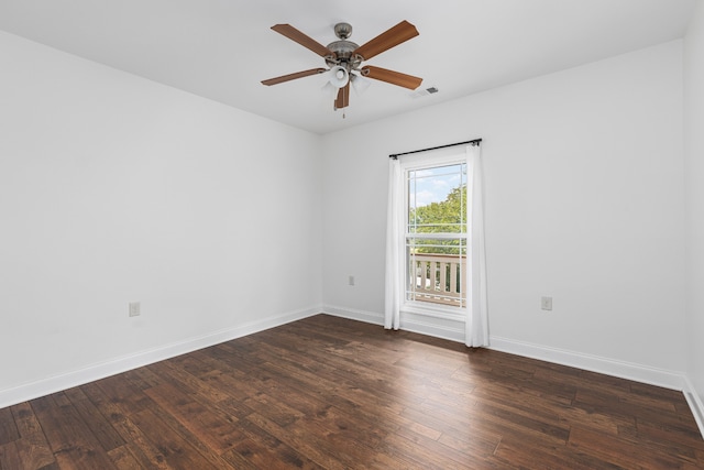 empty room with dark hardwood / wood-style flooring and ceiling fan