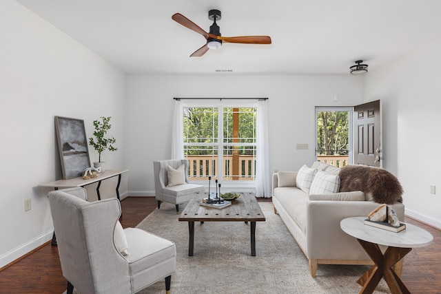 living room featuring ceiling fan and hardwood / wood-style flooring