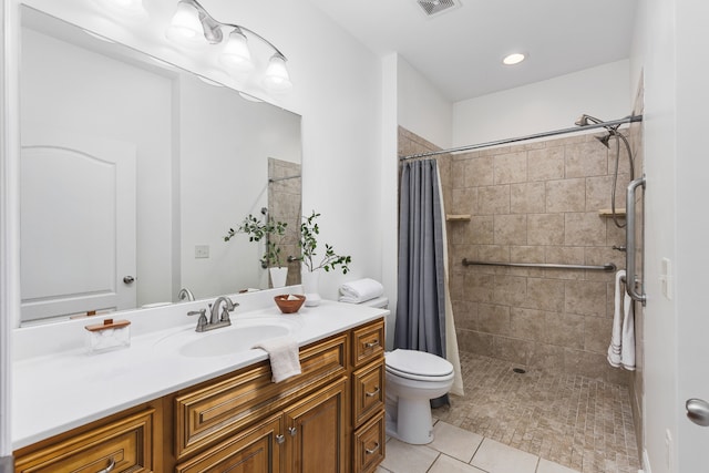 bathroom featuring walk in shower, vanity, toilet, and tile patterned floors