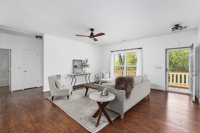 living room featuring ceiling fan and dark hardwood / wood-style flooring