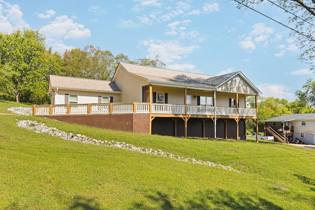 rear view of house with a yard and a deck