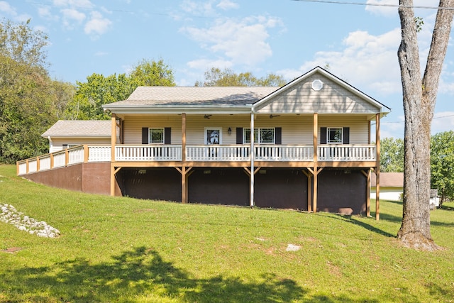 rear view of house with a deck and a yard