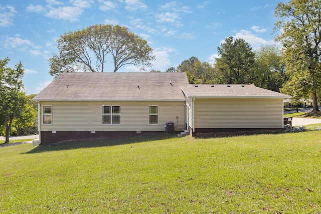 back of house with a lawn and central air condition unit